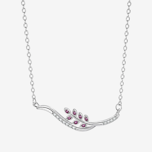 A JOET silver-toned leaf-shaped pendant necklace with small clear stones and five pink gemstone accents, shown on a white background.