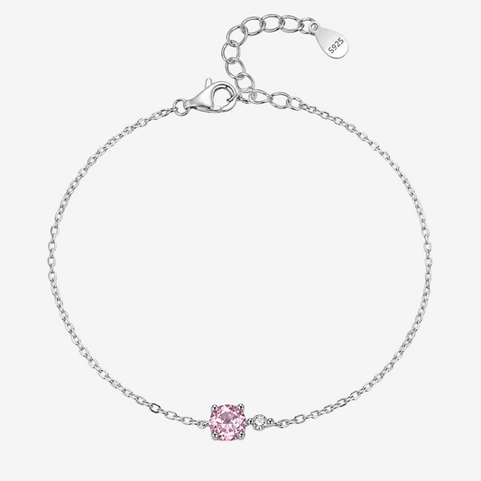 A JOET delicate sterling silver chain bracelet with a single pink gemstone accent, displayed on a clean white background. The bracelet features a lobster clasp, an adjustable extender chain with a '925' silver hallmark tag, and a small pavé setting holding the pink stone.