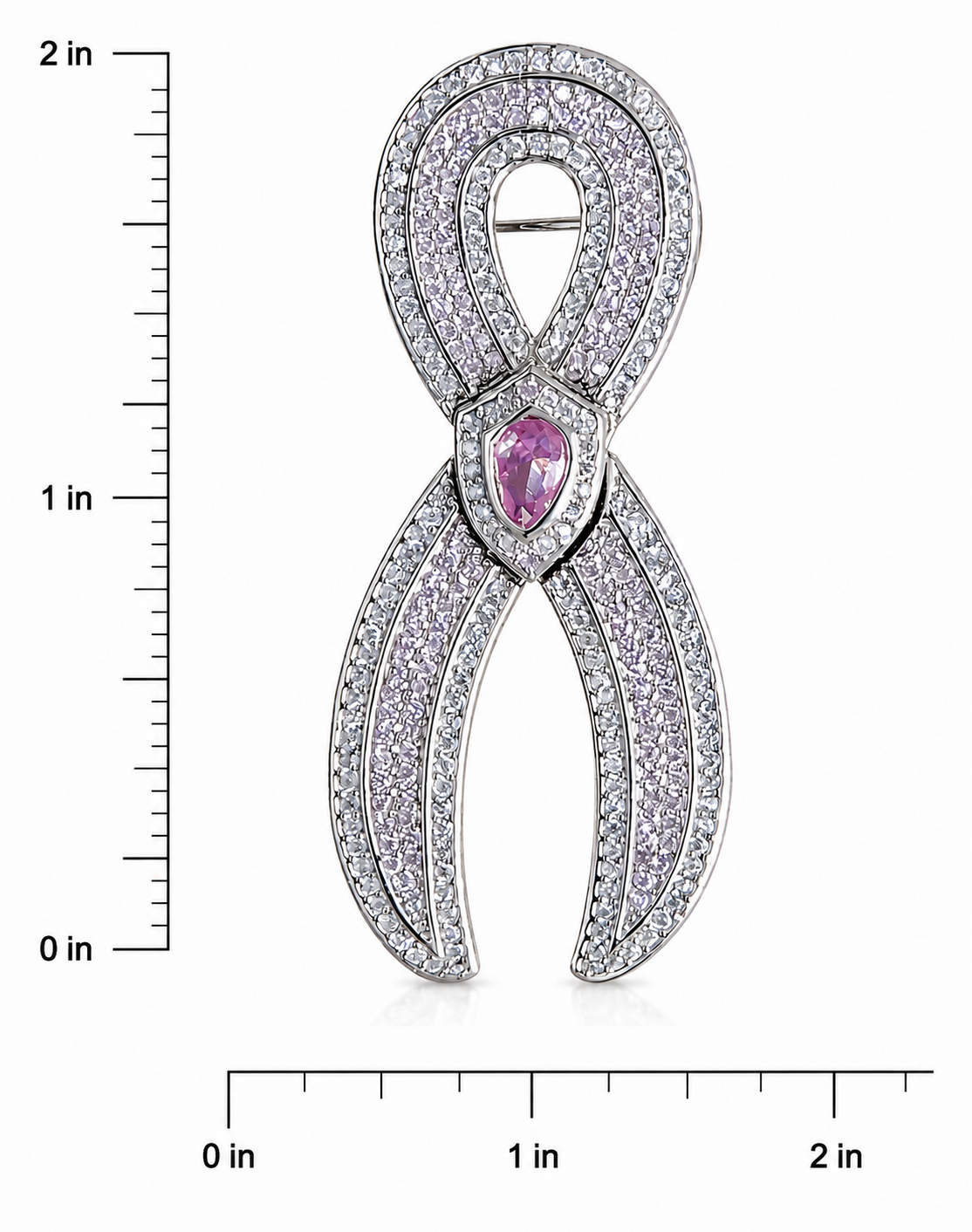 A JOET silver-toned ribbon-shaped brooch paved with clear stones and featuring a central teardrop-shaped pink gemstone, shown with inch measurement rulers on both sides and bottom.